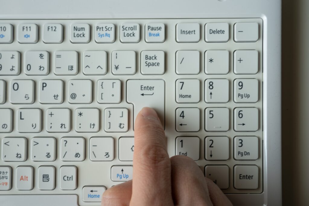 パソコンのキーボードを押す人