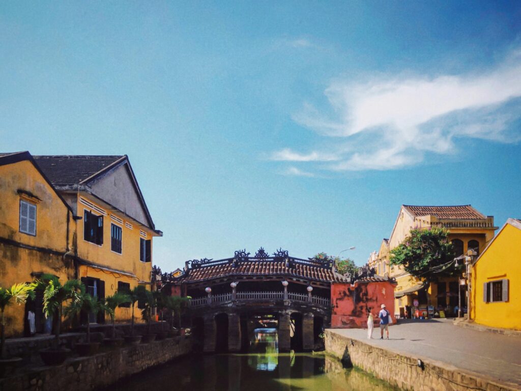 a bridge over a river between buildings