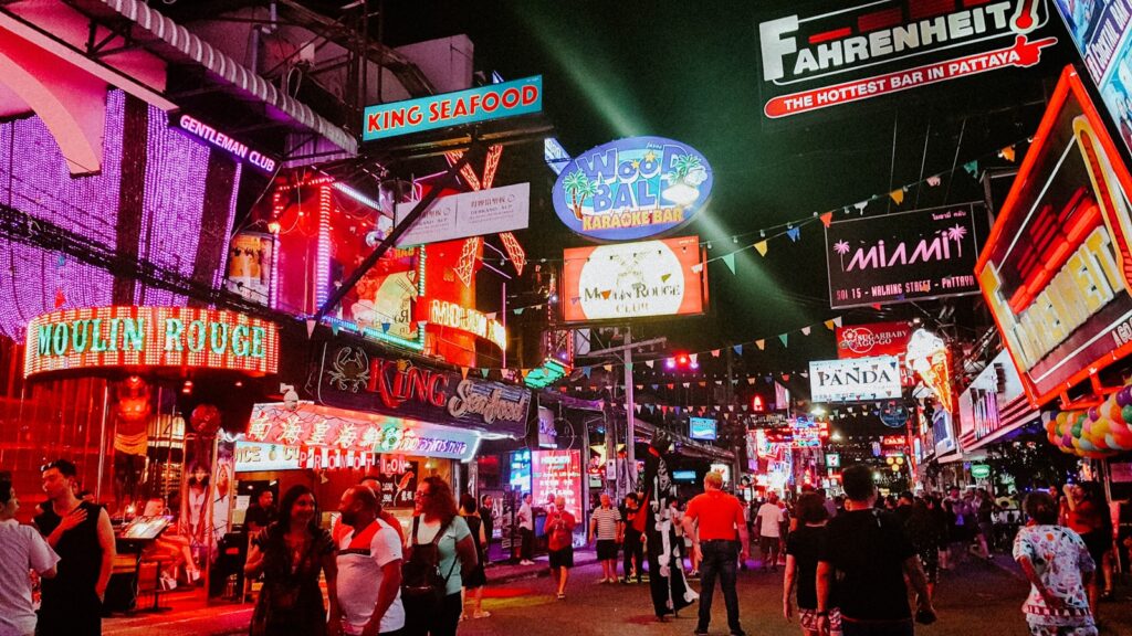 people standing between store buildings at nighttime