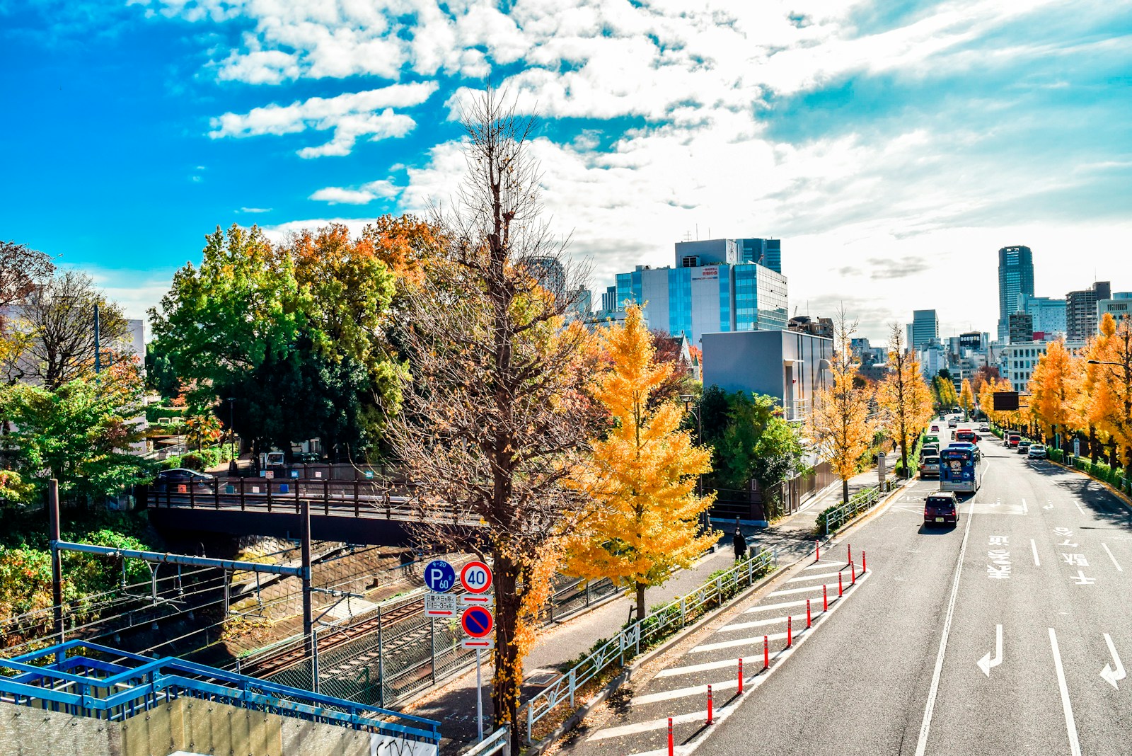 a view of a city street with a bridge in the background