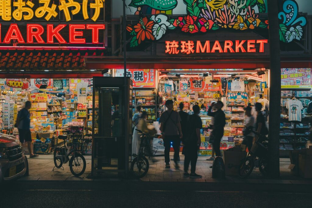 A group of people standing outside of a market