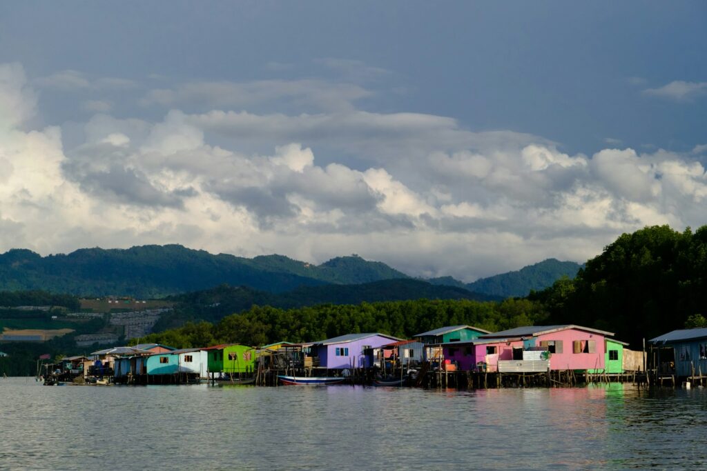 a group of houses sitting on top of a body of water