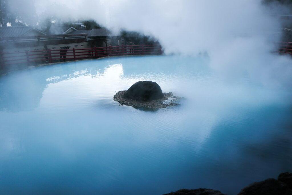 a body of water with a rock in the middle of it