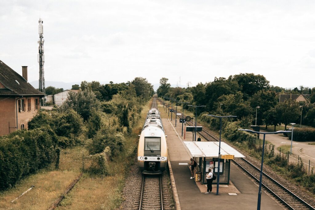 A train traveling down tracks next to a train station