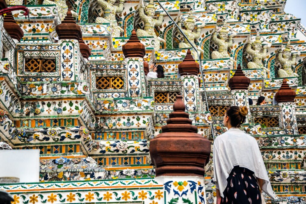 people walking on gold and white temple during daytime