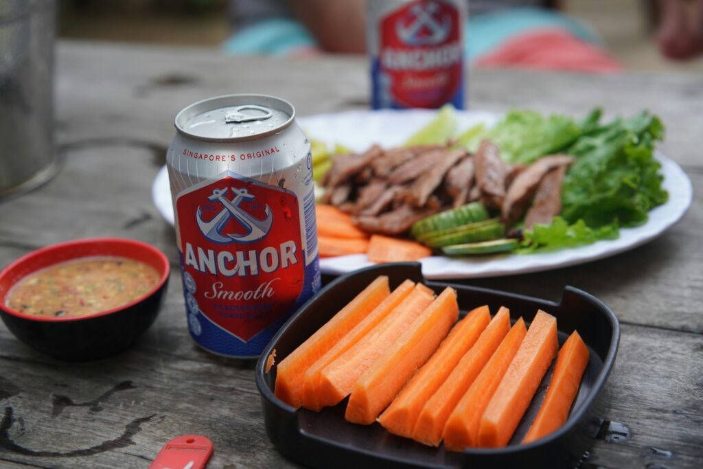 a plate of food and a can of soda